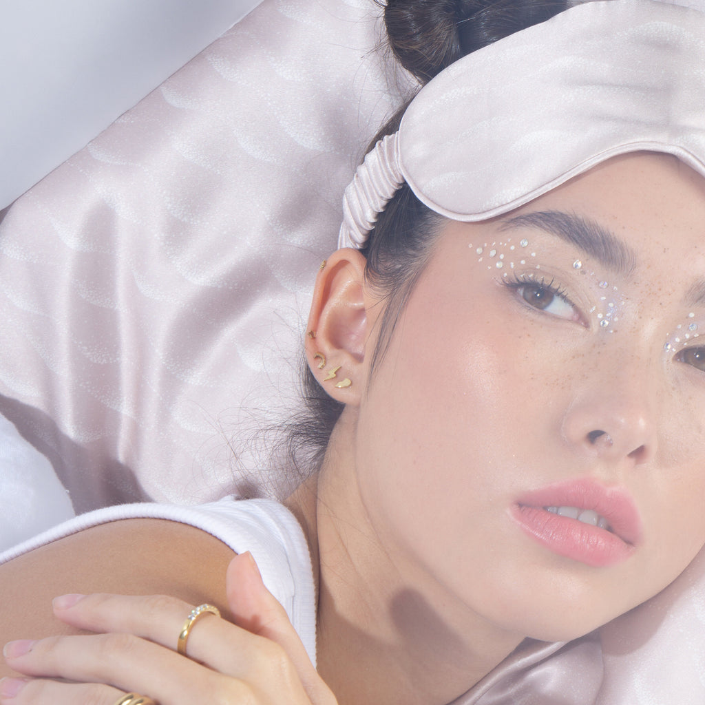 Woman resting on a lilac silk pillowcase