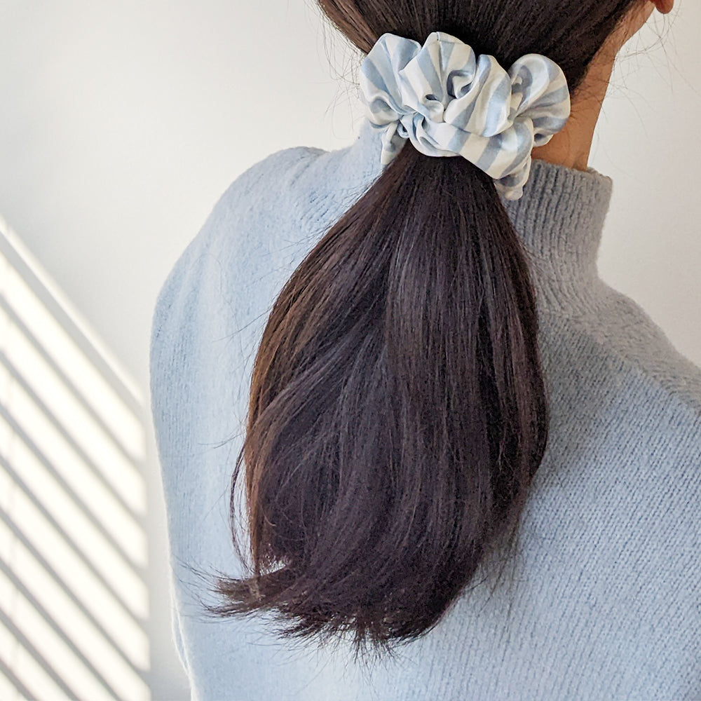 Silk scrunchie in Simple Stripe print tied in a pony tail 