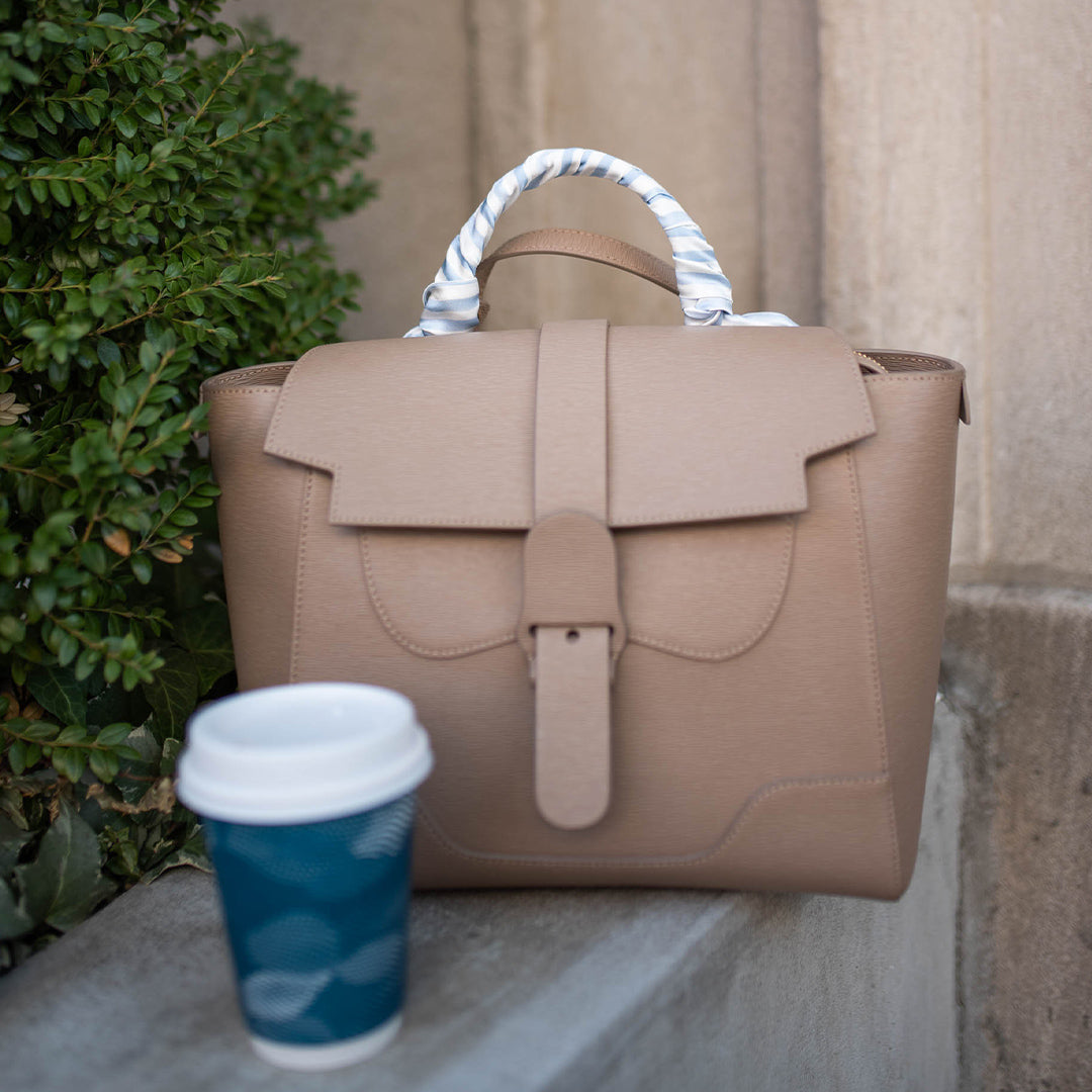 A handbag decorated with a silk ribbon